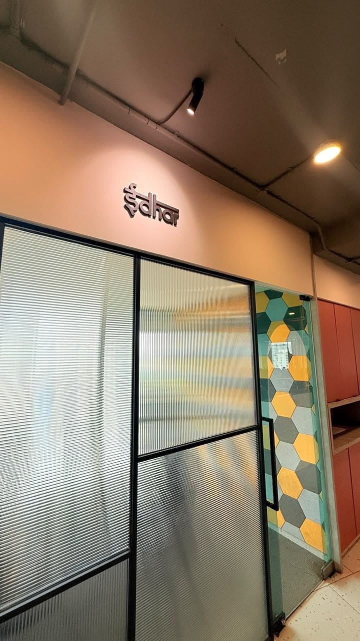 The Idhar meeting room at SoCheers, hexagon tile beside the door