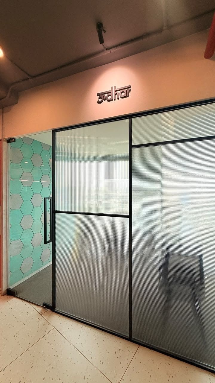 The Udhar meeting room at SoCheers, teal hexagons through the door