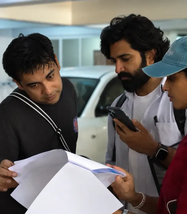 The SoCheers team going over a script on set