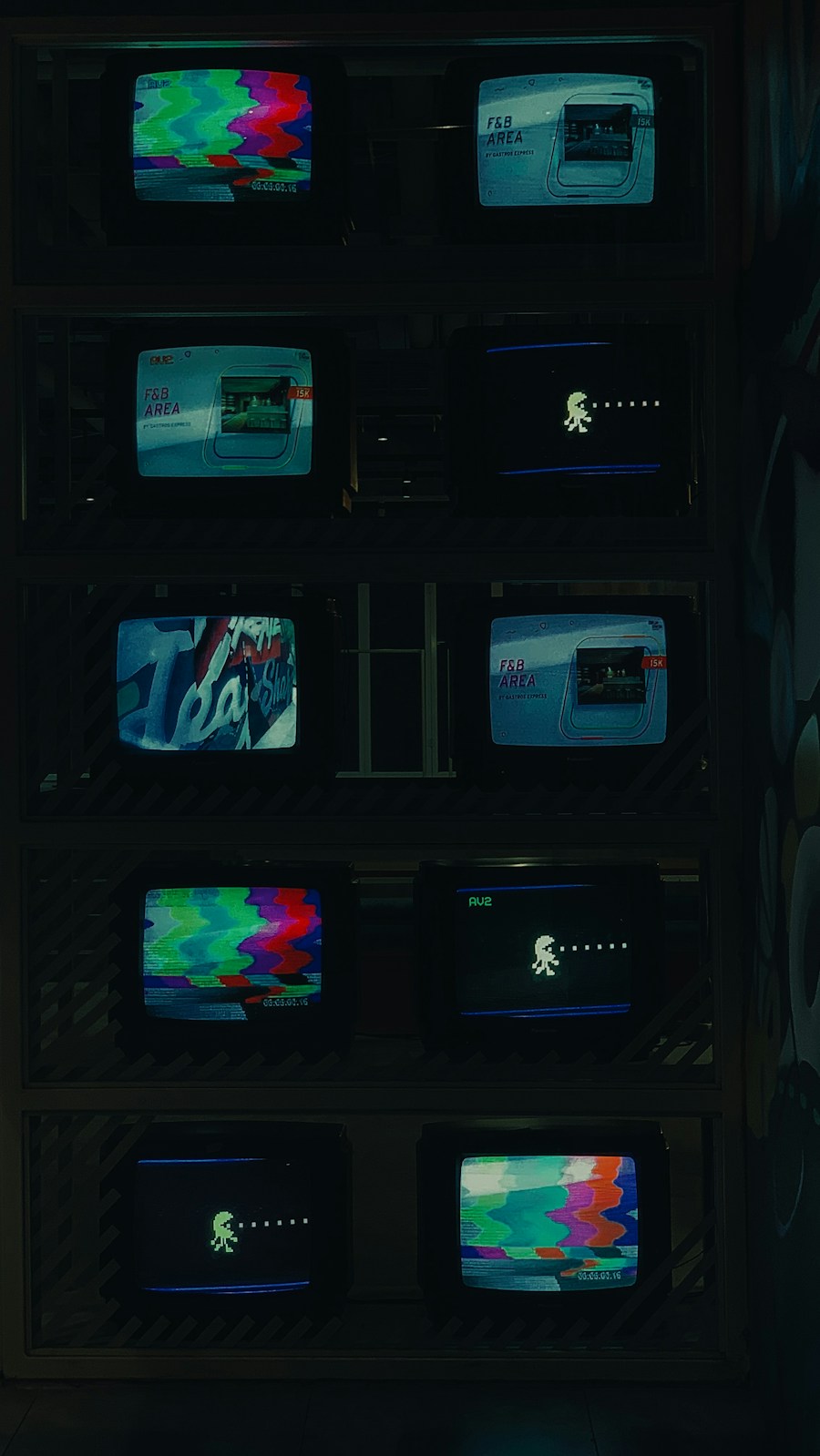 A wall of old televisions showing static