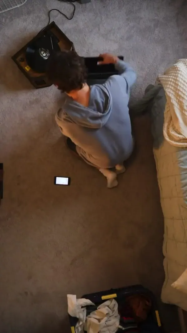 Overhead shot of a man on the floor beside his phone
